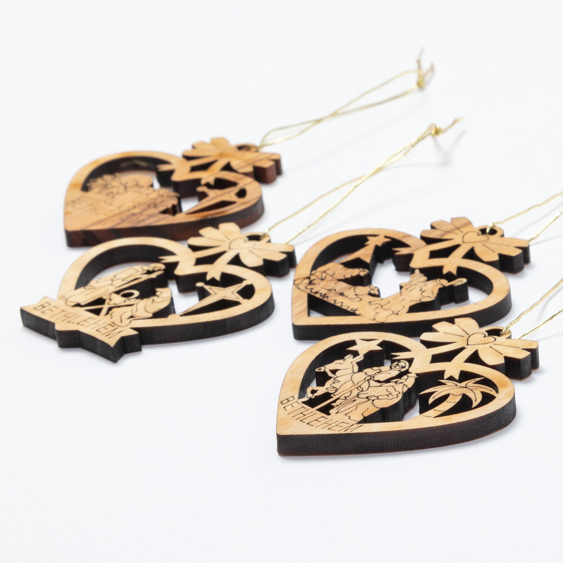 Four wooden hanging ornaments shaped like hearts, each with a different nativity scene cutout and the word 'BETHLEHEM' at the bottom, shown on a plain white background.