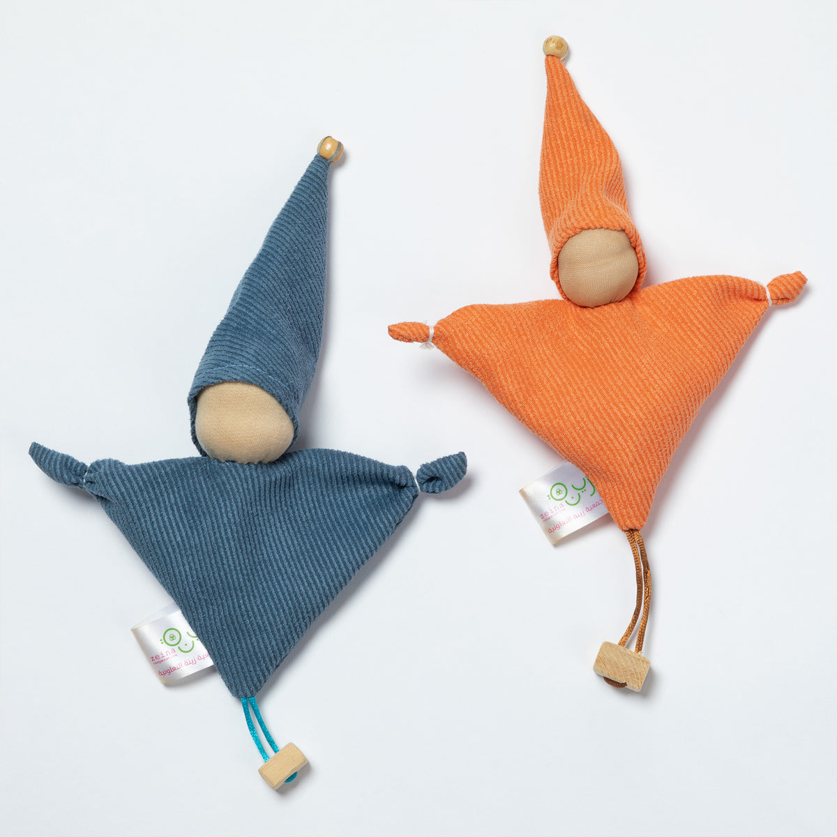 Two triangular fabric gnomes with pointed hats on a clean white background. One gnome is made of blue corduroy fabric with a wooden face and hat tip, and the other is made of orange corduroy fabric with a wooden face and hat tip.