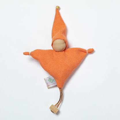 An orange textured fabric doll toy with a wooden head, pointed hat, and small tag, photographed on a clean white background.