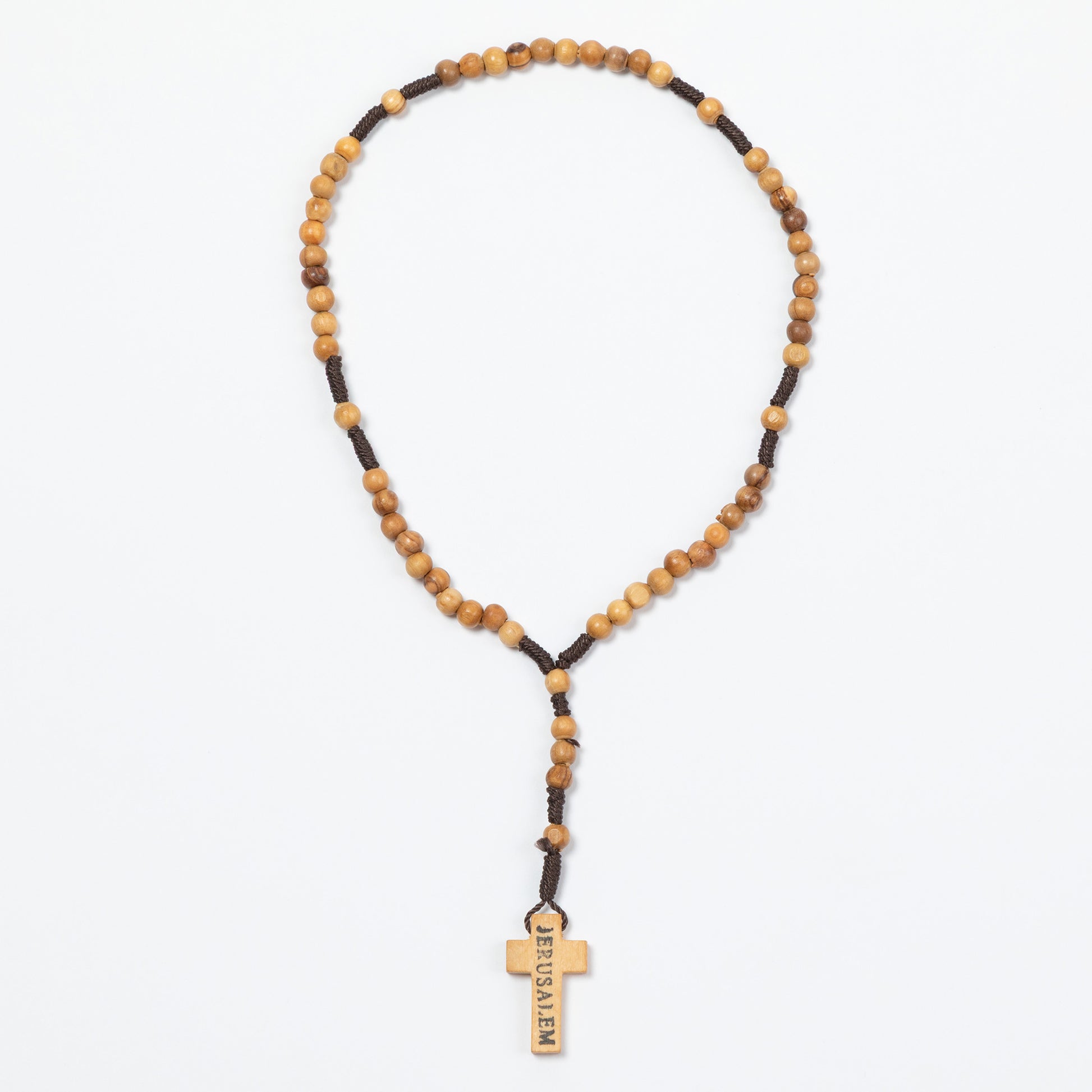 Necklace with wooden beads and a cross pendant on a white background