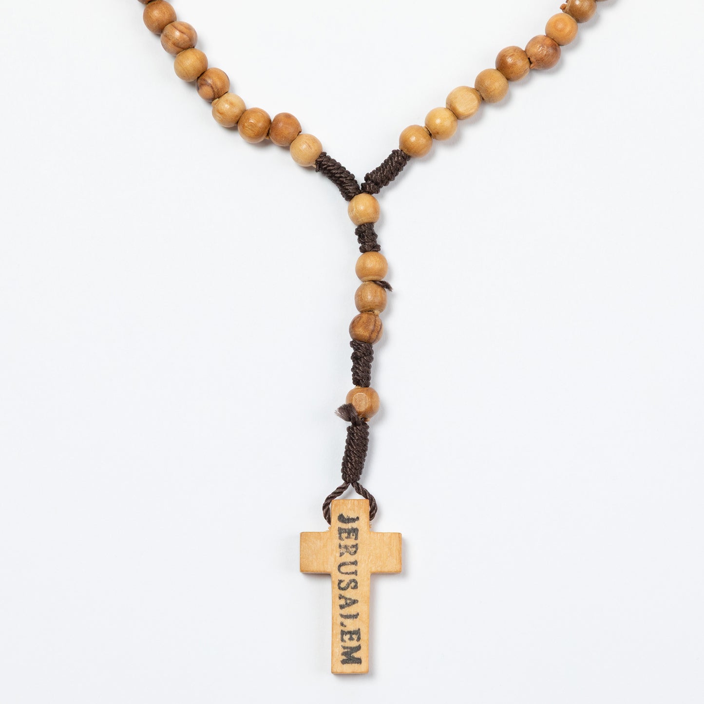 Wooden rosary with cross pendant on a white background