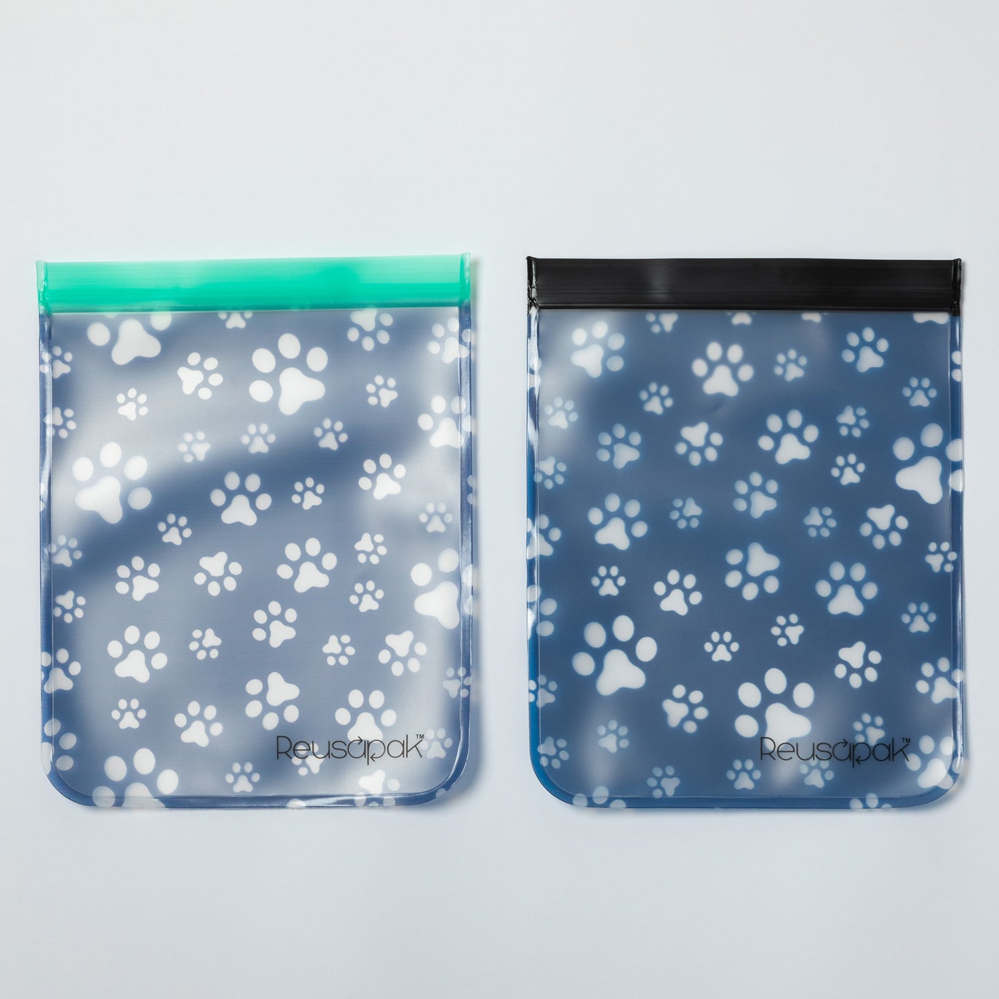 Two reusable bags with paw print pattern on a light gray background