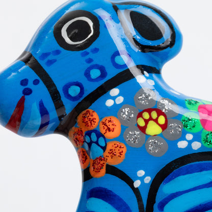 Close up of a colorful hand painted dog magnet.