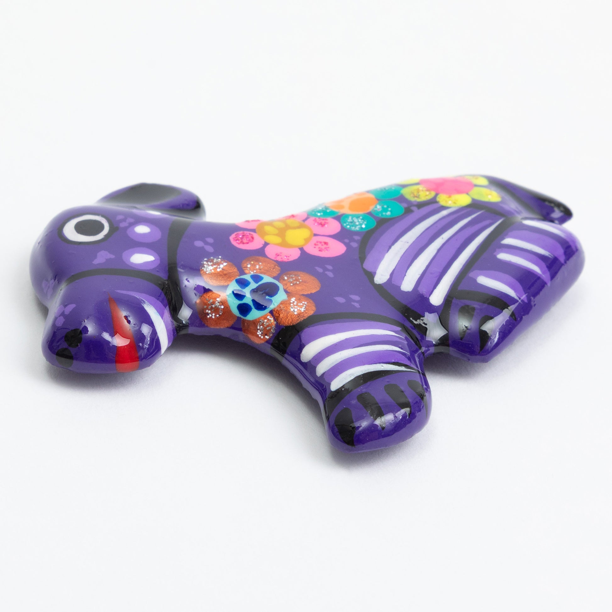 Purple hand painted ceramic dog magnet against a white background.