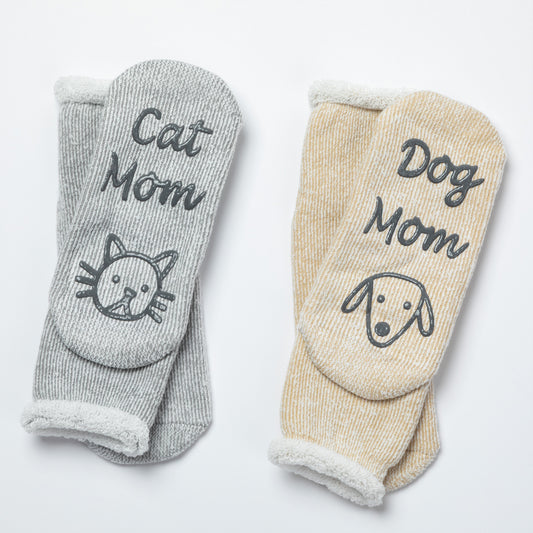 Two pairs of socks, one gray with 'Cat Mom' and a cat illustration, the other beige with 'Dog Mom' and a dog illustration, on a white background.