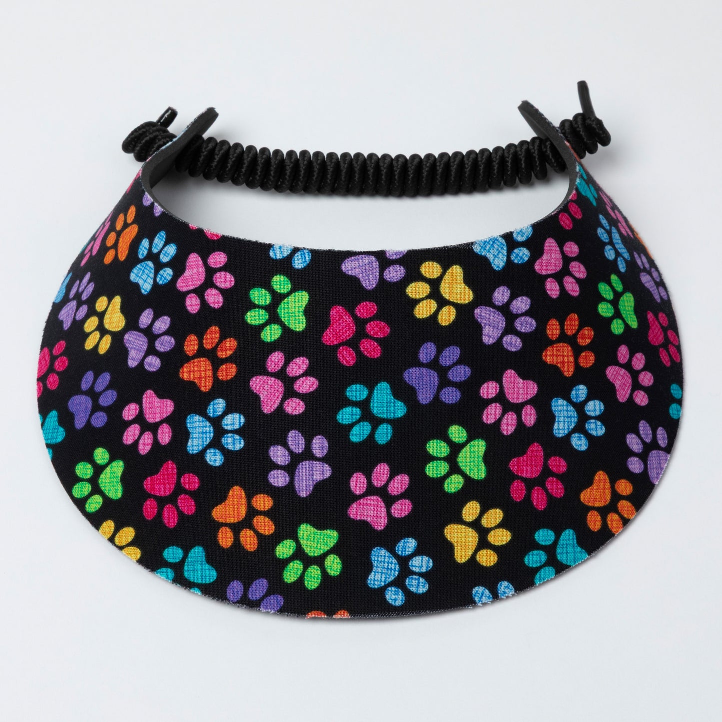 Visor with colorful paw pattern on a black background