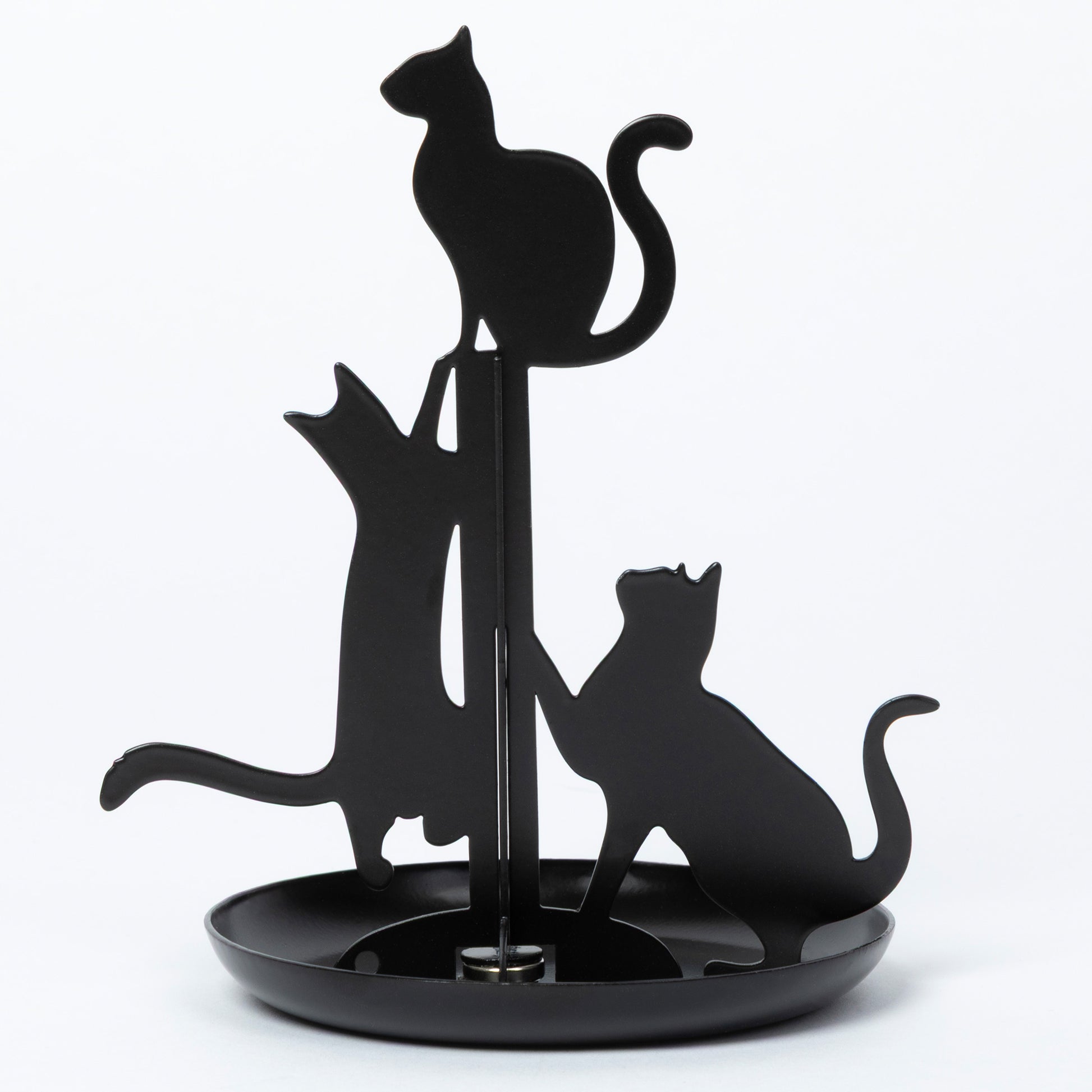 Black metal cat-shaped jewelry holder with three cat silhouettes on a round base, photographed against a plain white background.