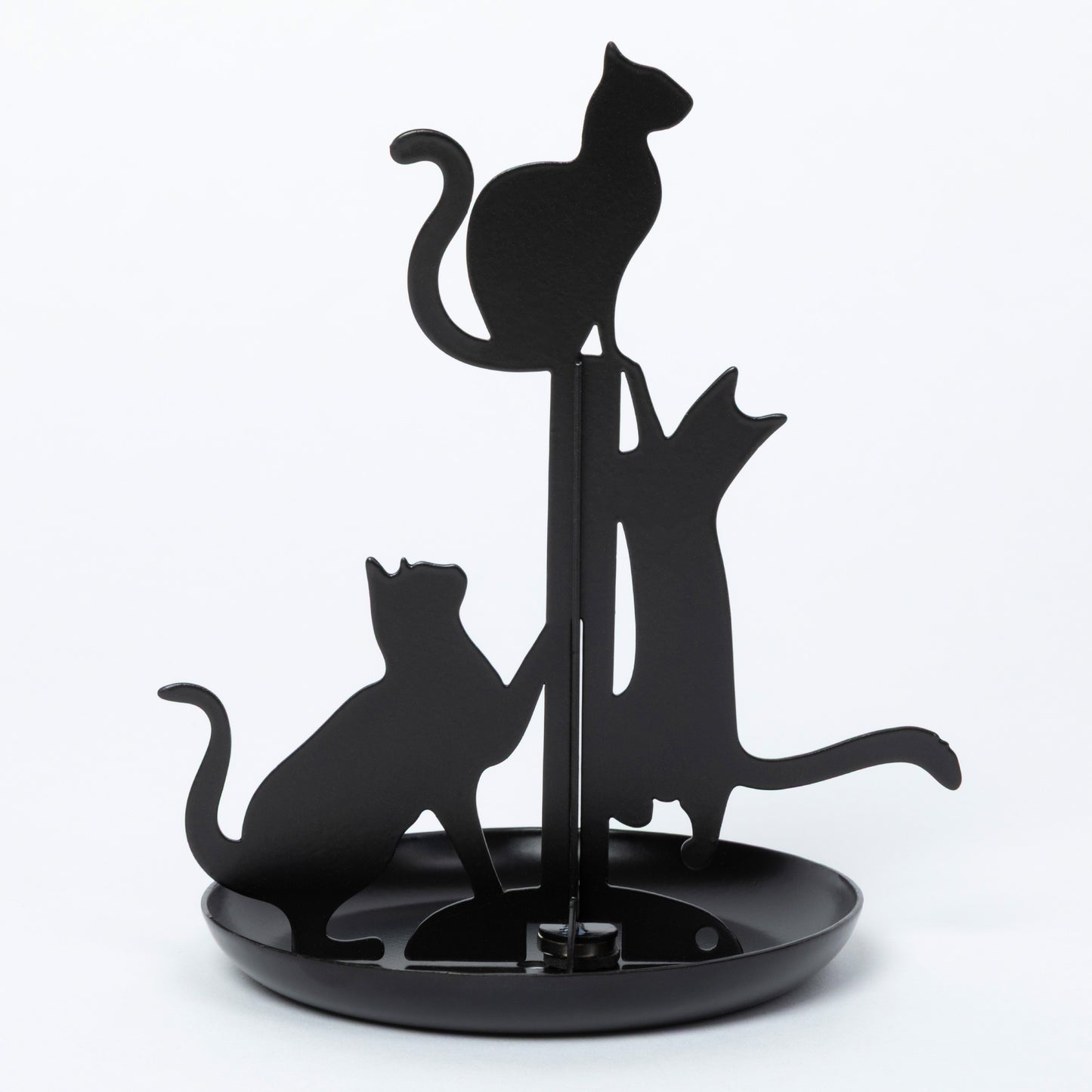Black metal cat silhouette stand with three cat cutouts on a round base, photographed against a plain white studio background.