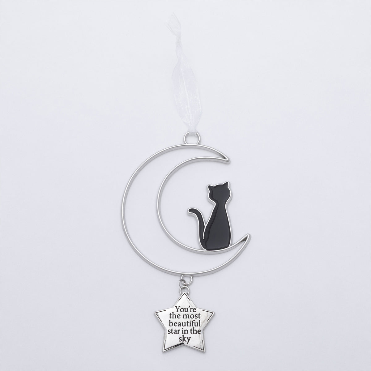 A silver crescent moon and star ornament hanging from a white ribbon. The crescent moon features a black enamel cat silhouette, and a small silver star charm below reads, 'You're the most beautiful star in the sky'.