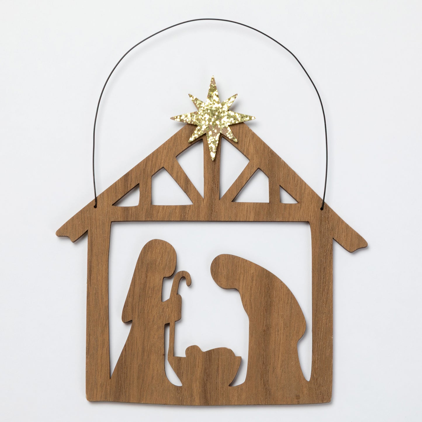 A wooden Nativity scene ornament with a star on top, shown on a plain light background.