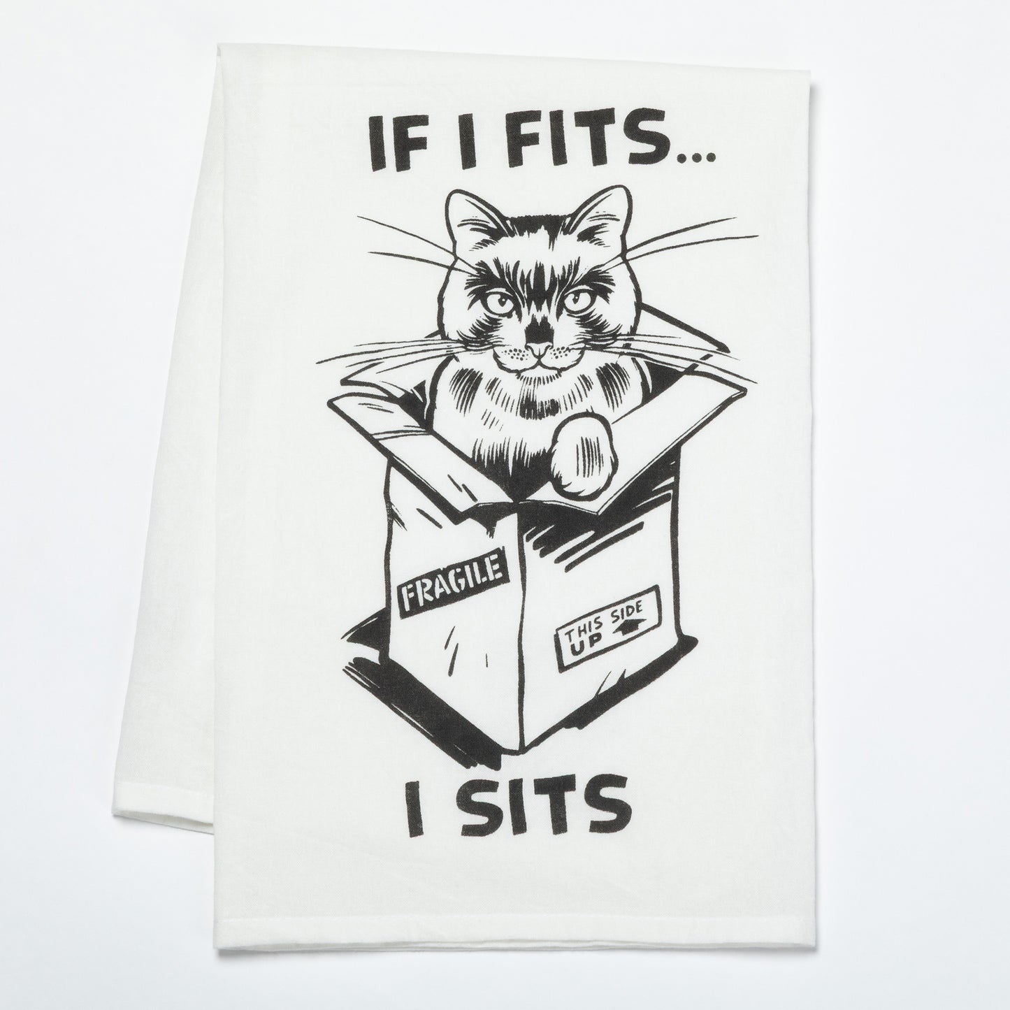 Cat in a box with humorous text on a white dish towel