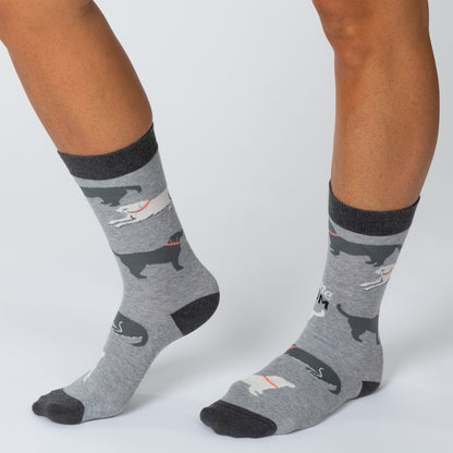 Feet wearing gray socks with dogs all over and the phrase "Awesome dog mom" with an arrow pointing up.
