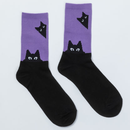 A pair of crew socks with a split design: the upper portion is lavender purple with a black cat head graphic, and the lower portion is solid black.