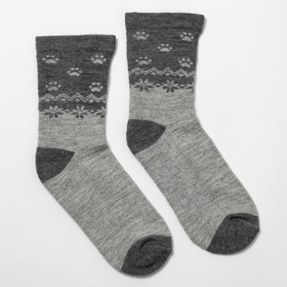 A pair of crew socks in heather gray with a darker gray patterned upper section featuring paw prints and snowflake motifs, shown on a plain white background.