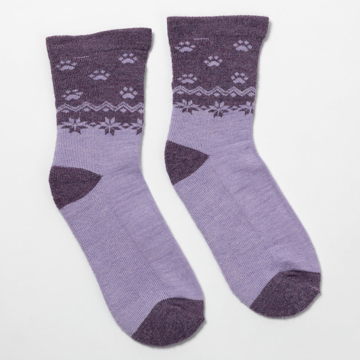 A pair of lavender and dark purple crew socks with a knit paw print and snowflake pattern around the upper leg, displayed on a clean white background.