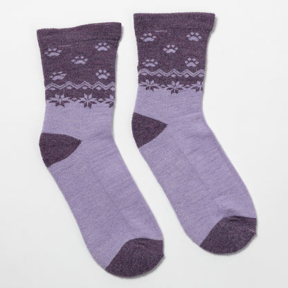 A pair of lavender and dark purple crew socks with a knit paw print and snowflake pattern around the upper leg, displayed on a clean white background.