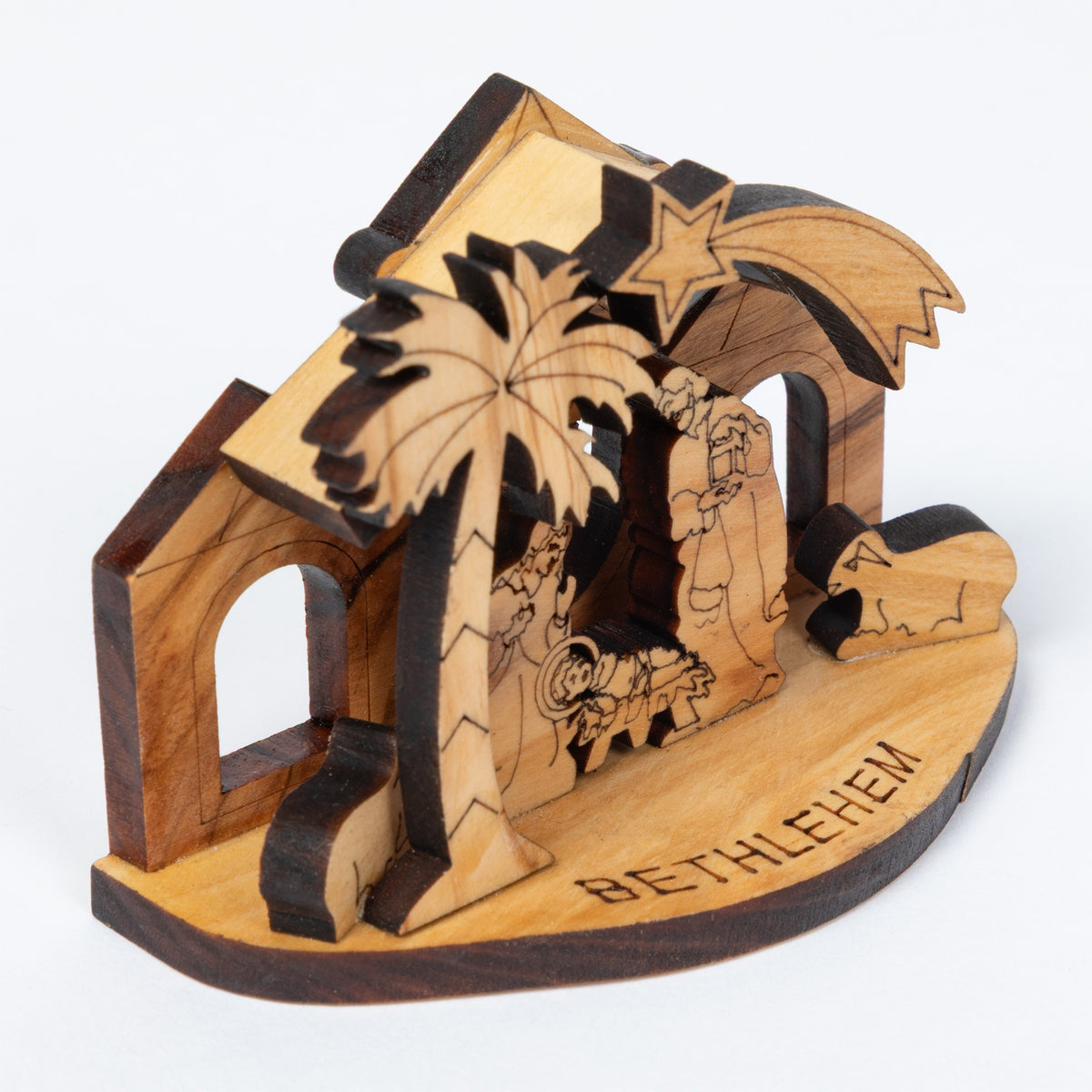 A handcrafted wooden nativity scene stand engraved with 'BETHLEHEM' on the base, featuring a palm tree, star, and figures inside a stable-like structure, photographed on a clean white background.