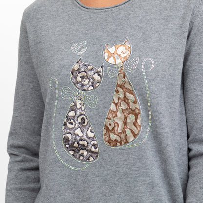 A close-up of a heather gray long-sleeve top featuring a rhinestone-embellished graphic of two stylized cats in leopard and mottled patterns, with a small heart above them.