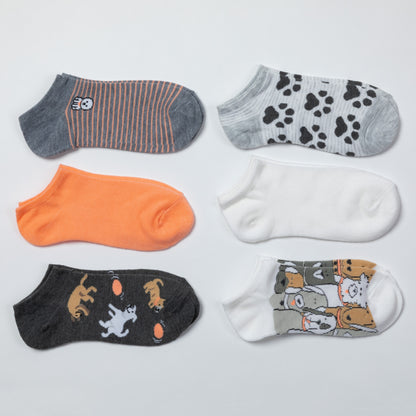 Six pairs of low-cut ankle socks arranged in a 2x3 grid on a light gray background. The designs include gray and orange stripes, gray paw prints, solid orange, solid white, black with cat and ball motifs, and a white pair with cartoon cat illustrations.