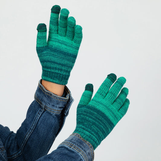 Green striped touch screen gloves worn with a denim jacket on a light gray background.
