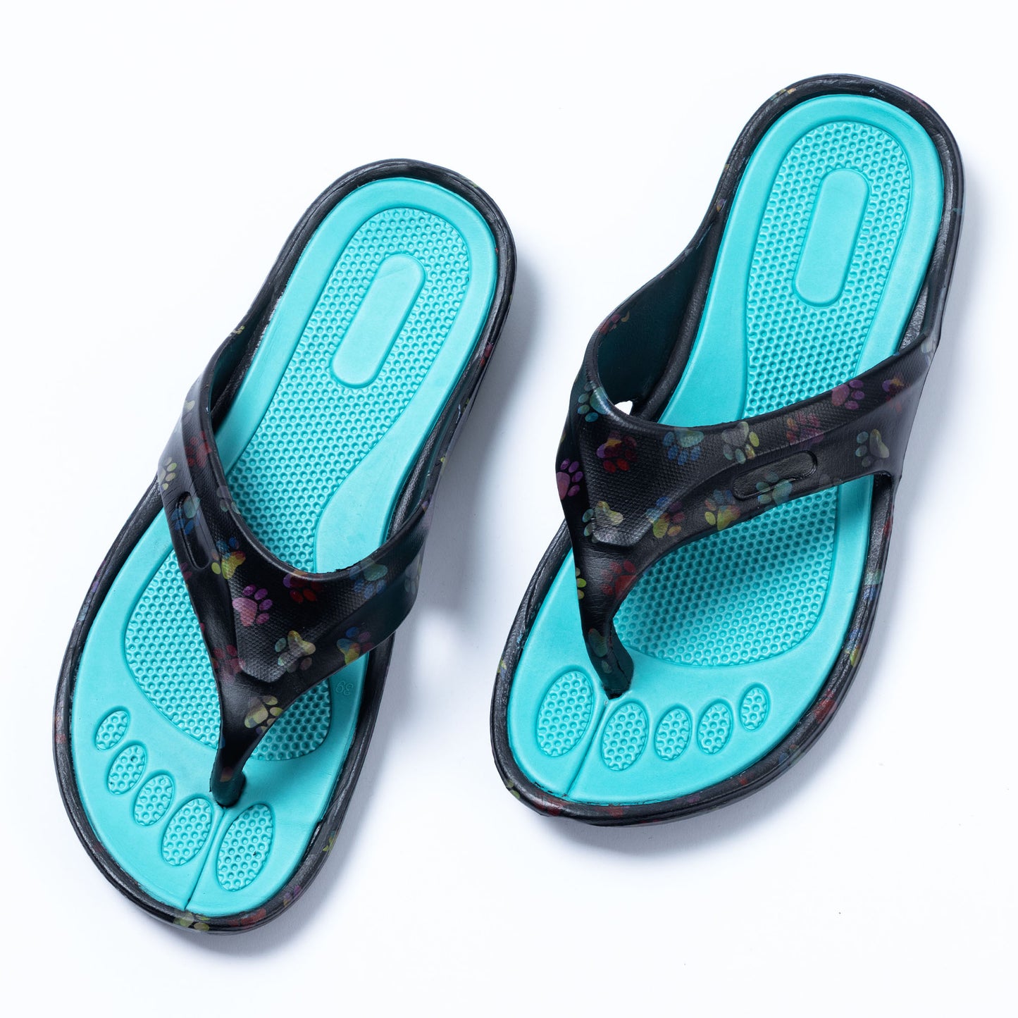 An image of pair of rainbow ombre paw EVA flip flops on white background The Rainbow Ombre Paw print is on a black background with a teal bright blue textured foot bed