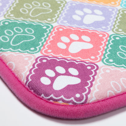 Colorful mat with paw prints on a white background