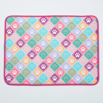 Colorful mat with paw print pattern on a white background