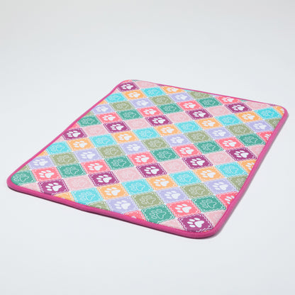 Colorful checkered mat with paw prints on a light gray background