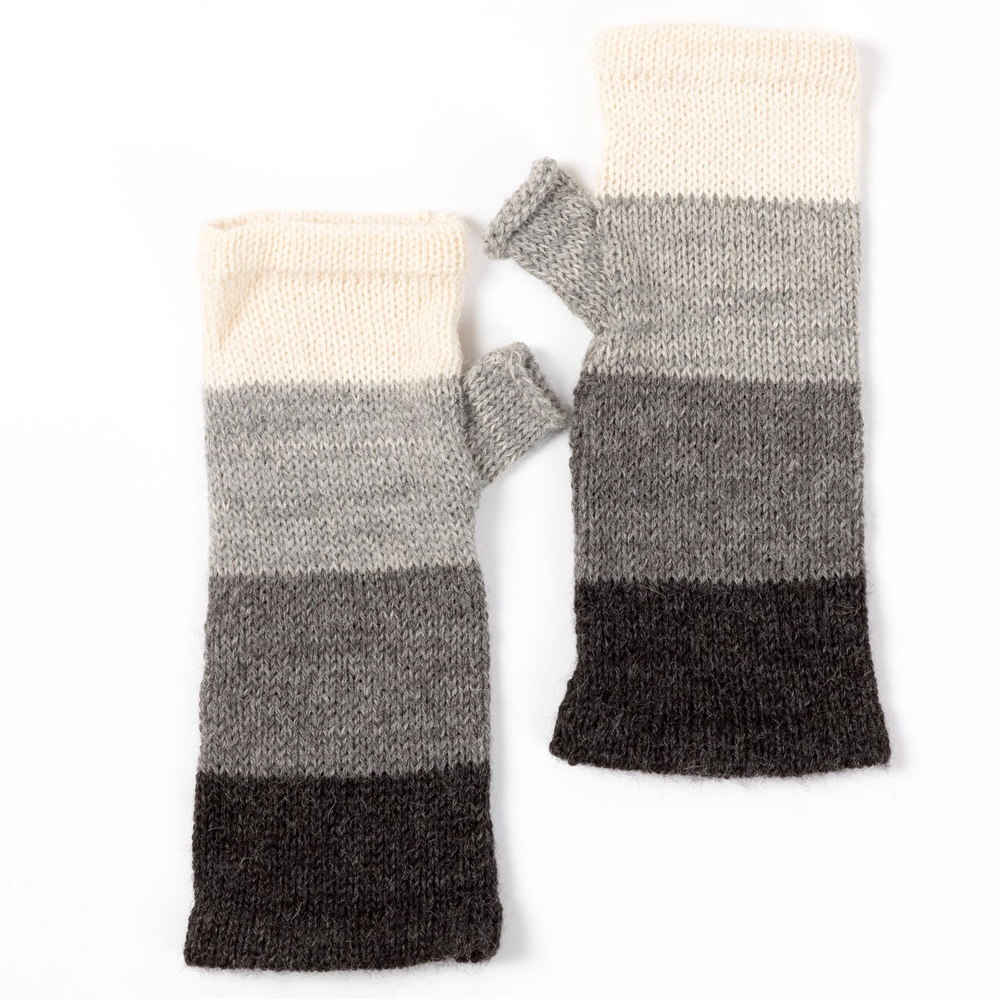 a pair of alpaca fingerless mittens in shades of gray made from alpaca wool on a white background