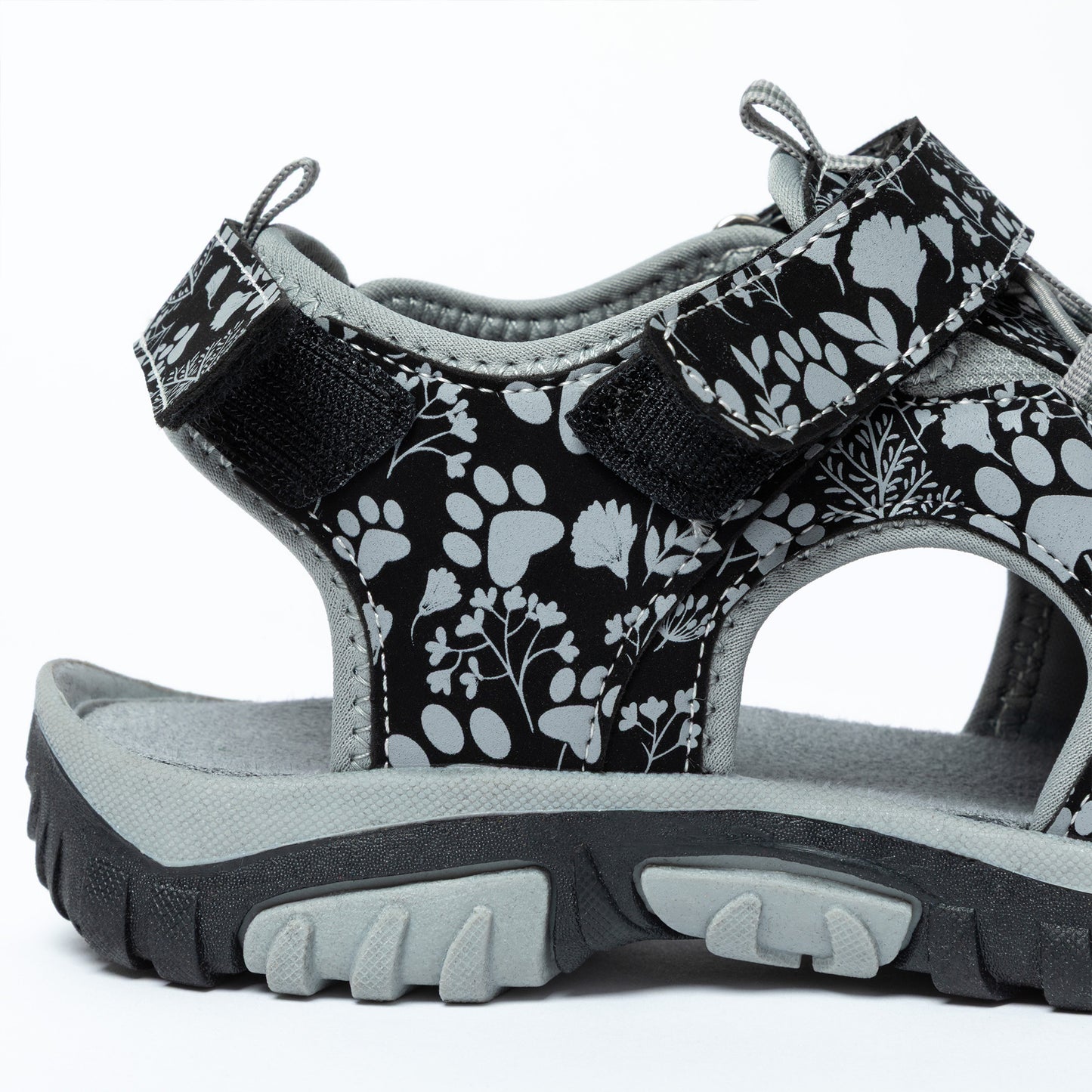 Black and gray floral patterned sandal with gray sole on a white background