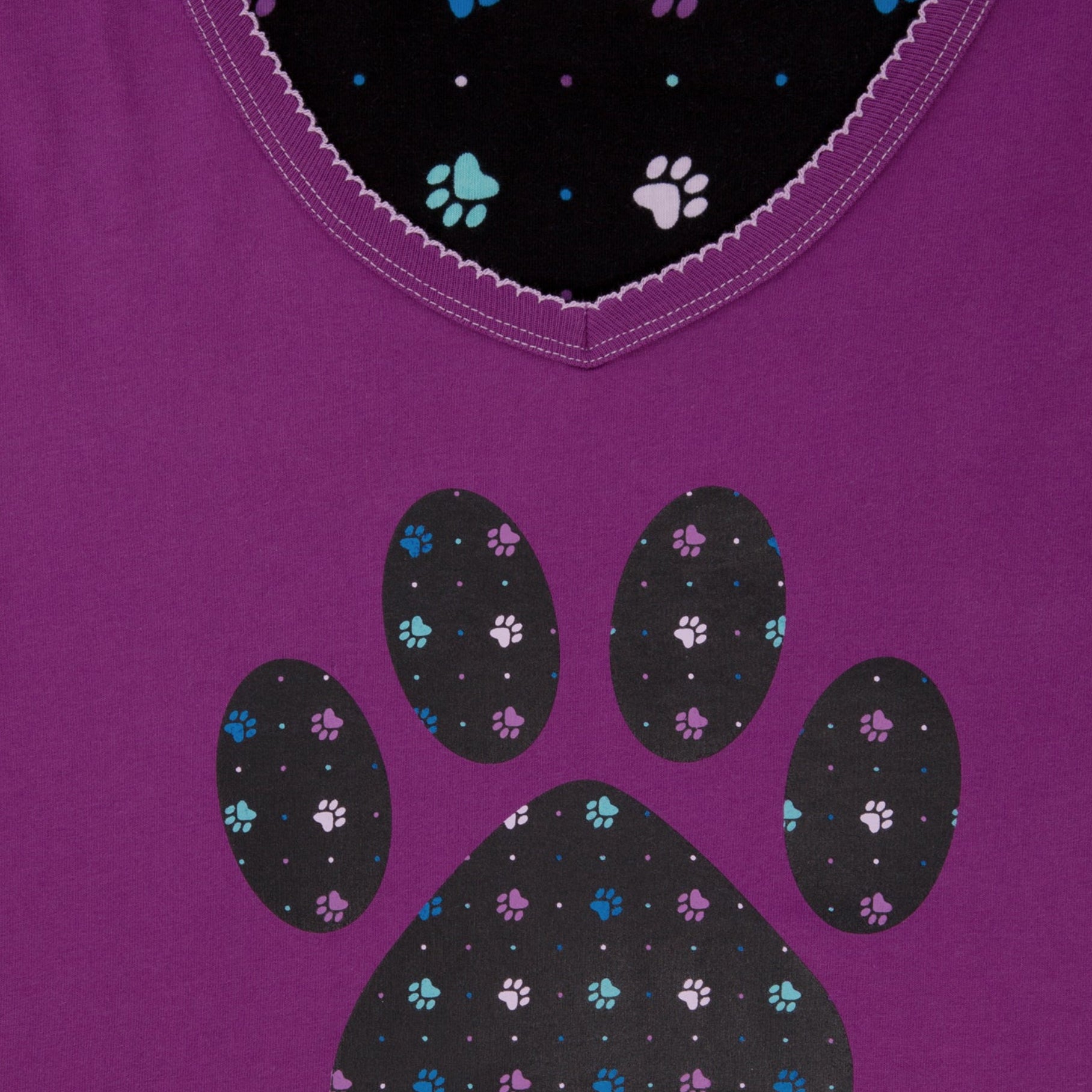 Purple shirt with polka dot paw print design on a white background