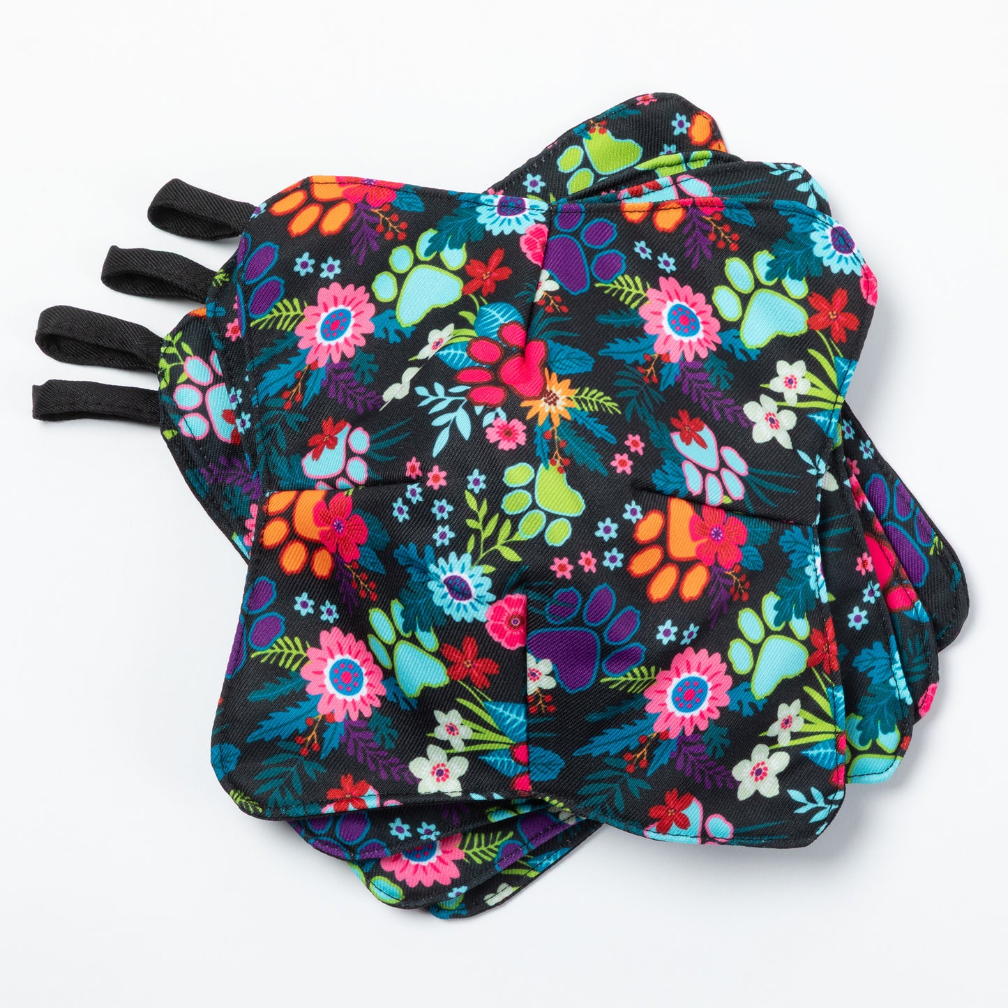 A set of four bowl cozies with various patterns, including a paw print and floral design, garden of paws