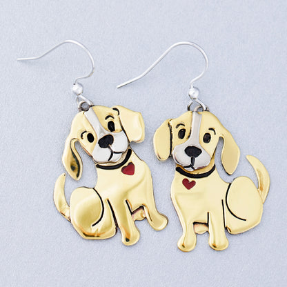 Brass dog-shaped earrings on a light gray background