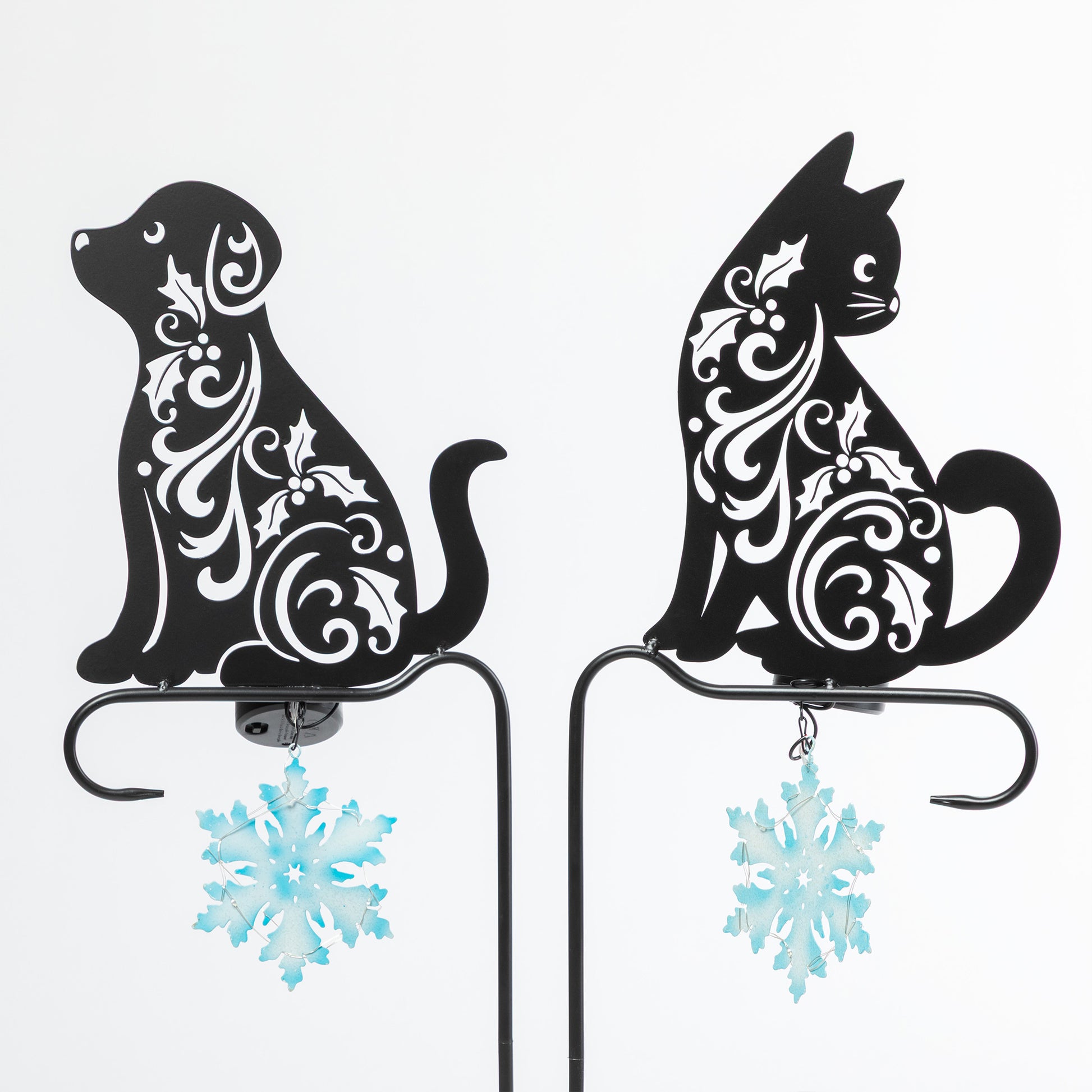 Decorative metal cat and dog silhouettes with floral patterns on a white background.
