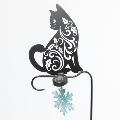 Decorative metal cat with snowflake design on a white background