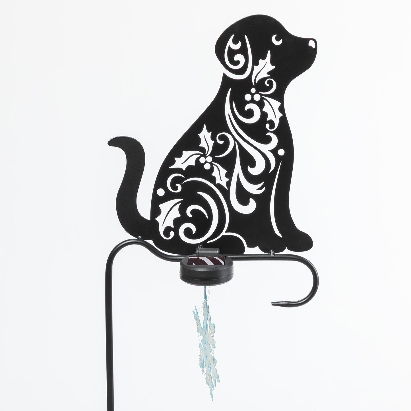 Decorative metal dog silhouette with white patterns on a white background