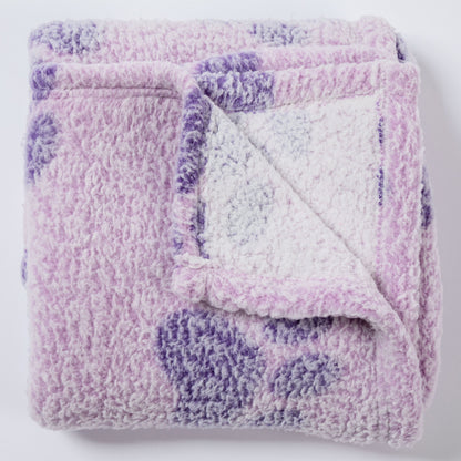 A folded plush sherpa blanket in lavender and purple with a white sherpa lining, shown on a clean white background.