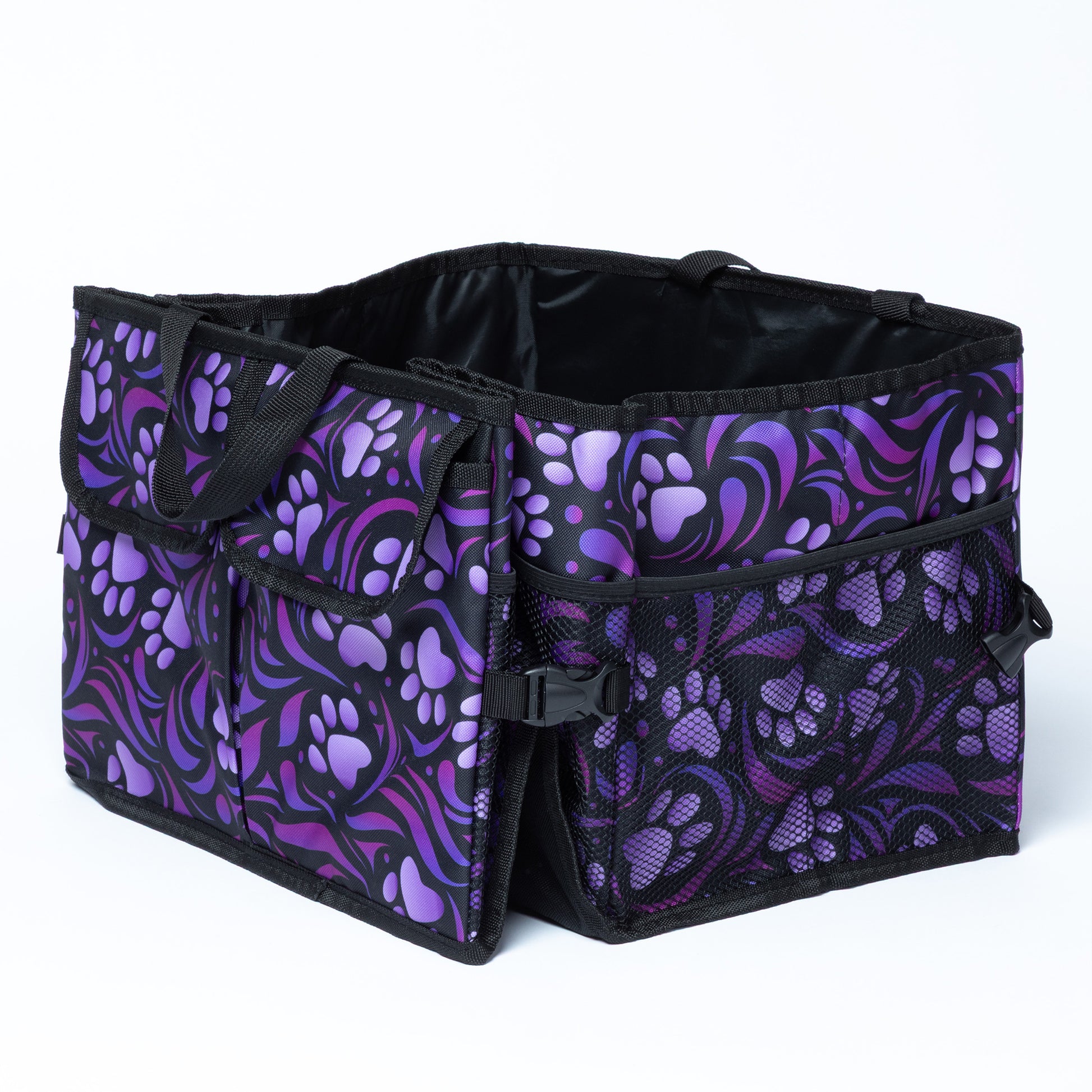A paw print patterned car trunk organizer with pockets on the front, and a mesh pocket on the side.