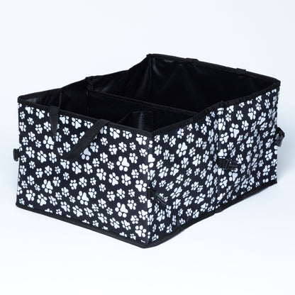 White paw print patterned car trunk organizer with buckles/clips on the side for adjustable size and collapsibility/storage, on a white background.