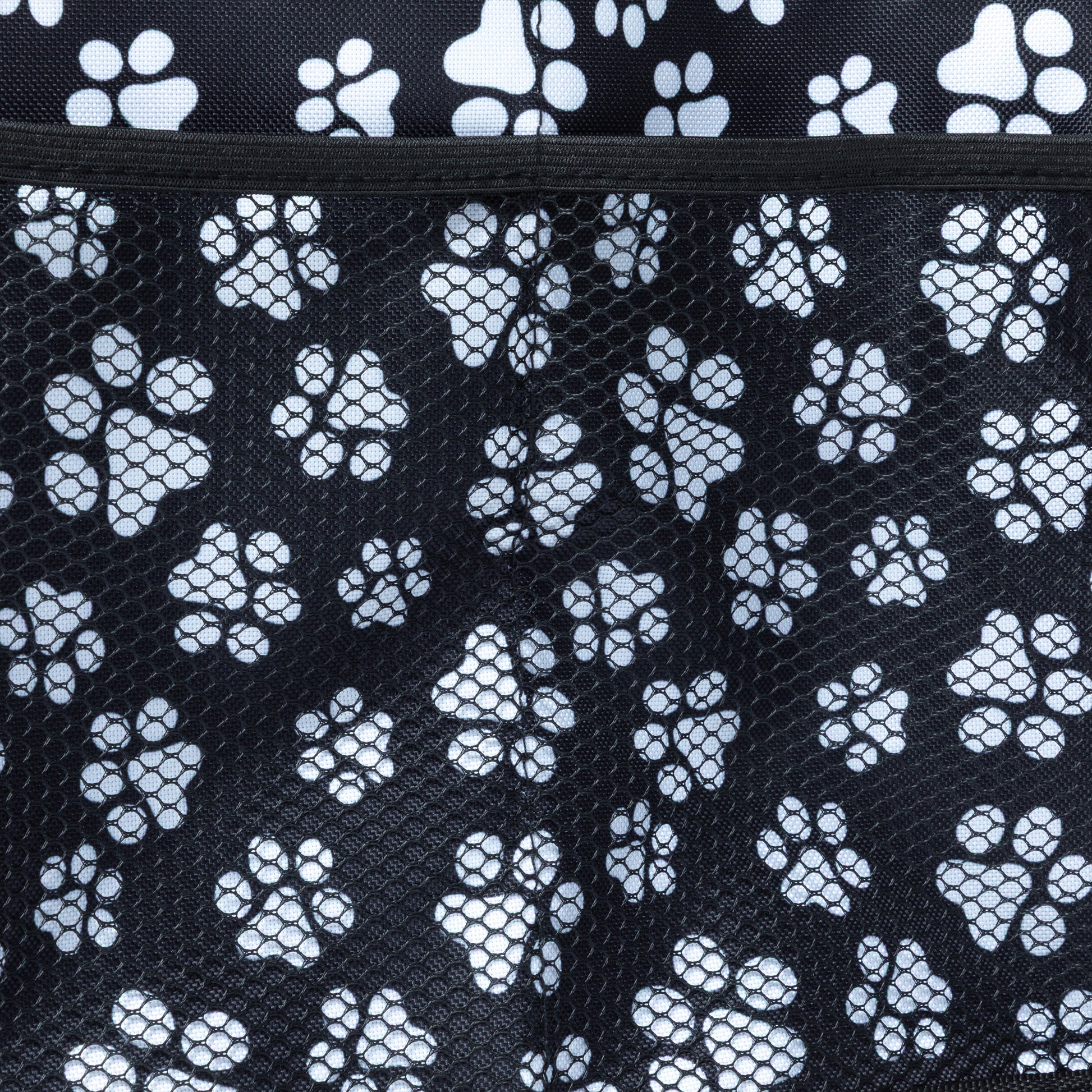 Close up of mesh side pocket on a paw printed car trunk organizer.