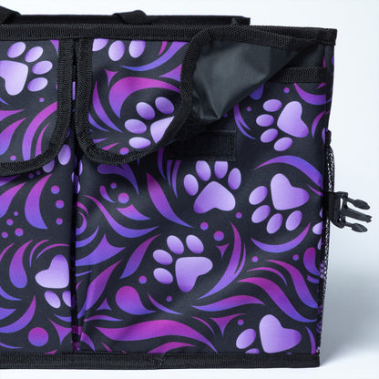 Close up of a flap closure pocket on the side of a collapsible car trunk organizer, featuring a purple paw print design.