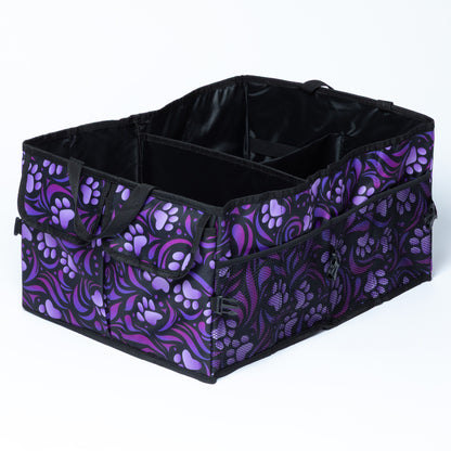 A collapsible car trunk organizer with purple paw prints and a purple and black swirl design, on a white background.