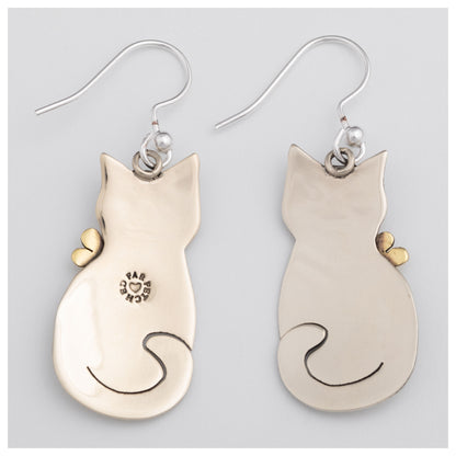 The back of cat-shaped earrings on a light gray background