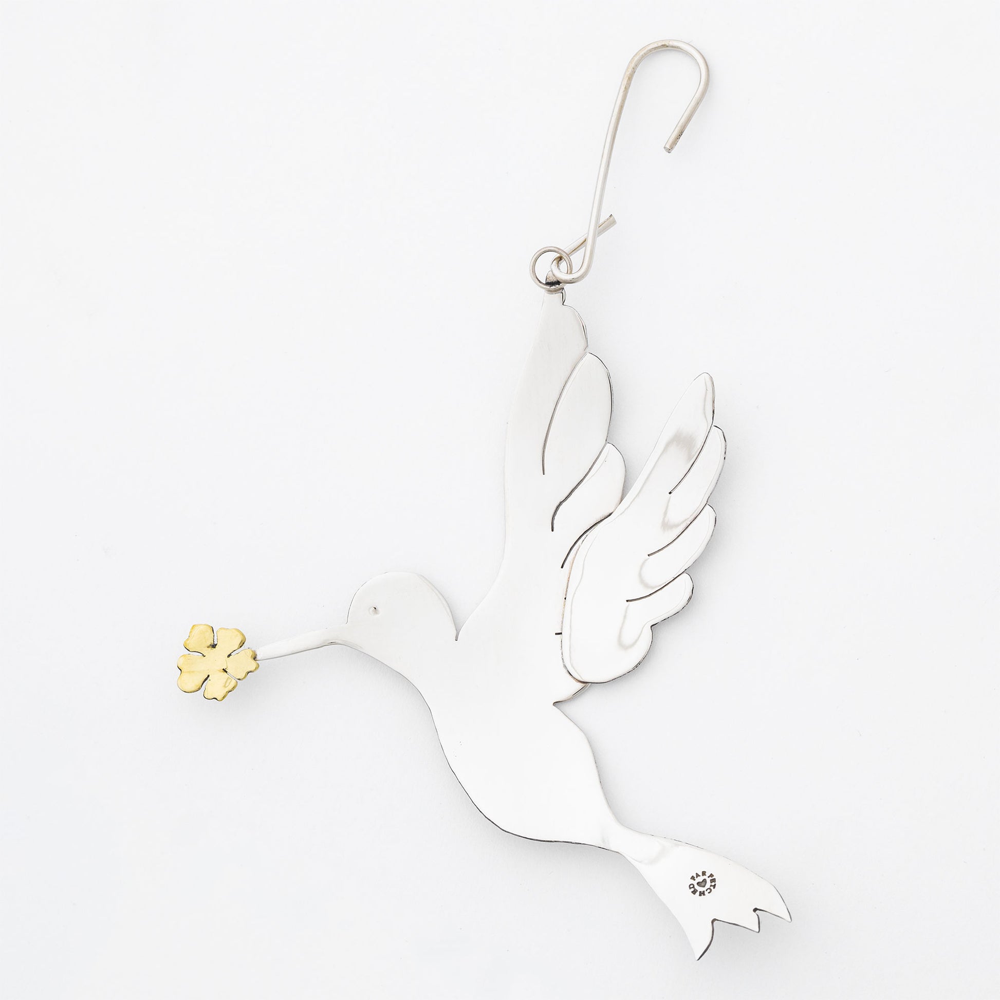 Decorative silver tone dove ornament with gold accents on a white background