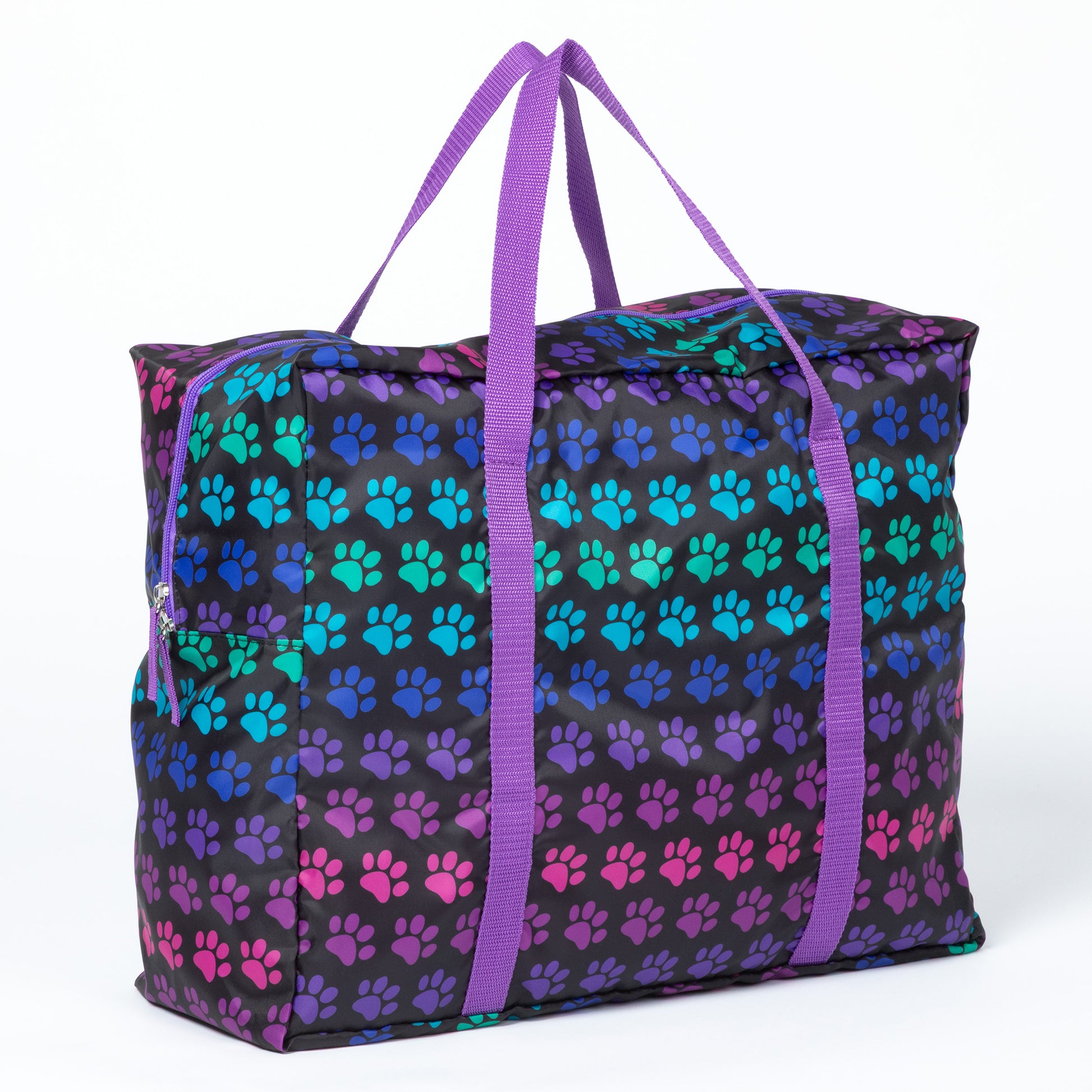 A duffel bag with colorful paw print pattern, purple straps on a white background