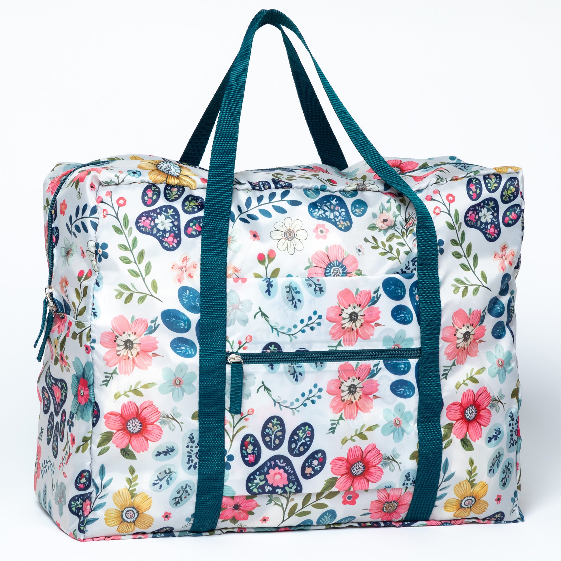 Floral patterned bag with blue straps on a white background