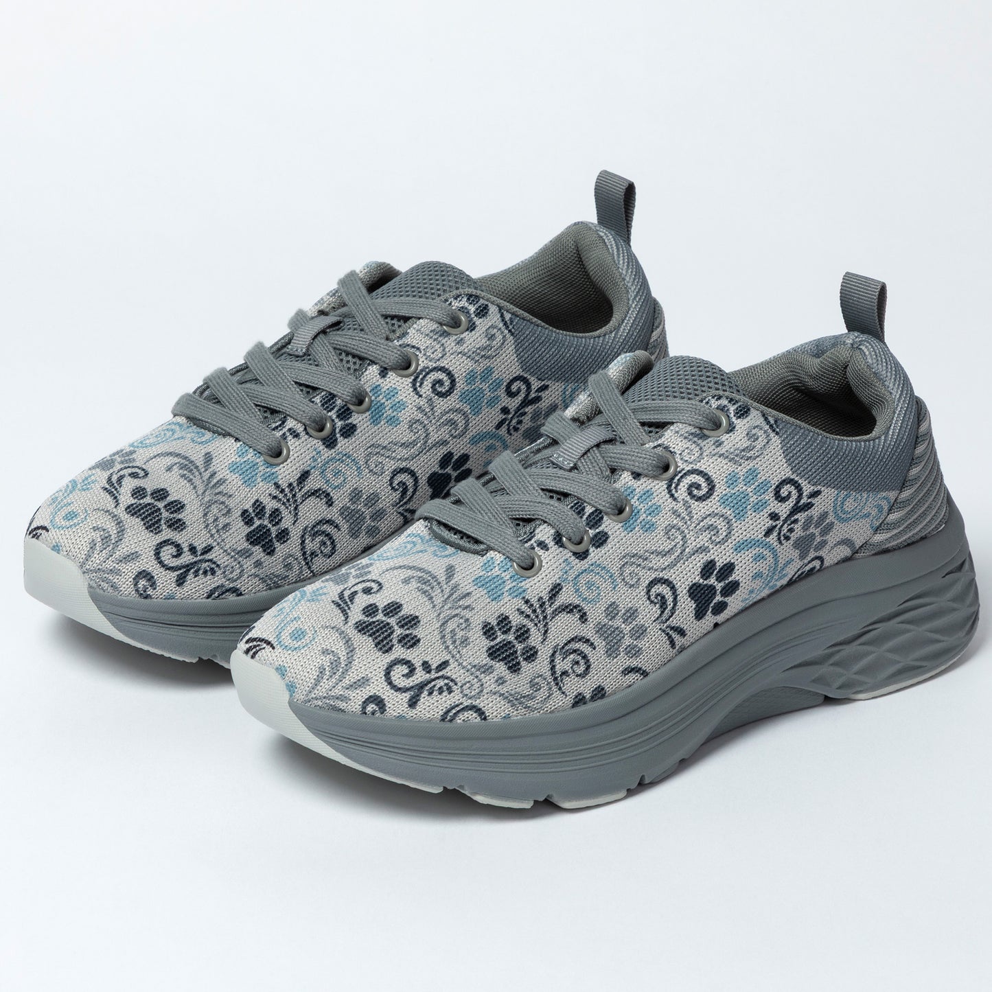 Gray sneakers with floral and paw print pattern on a white background.