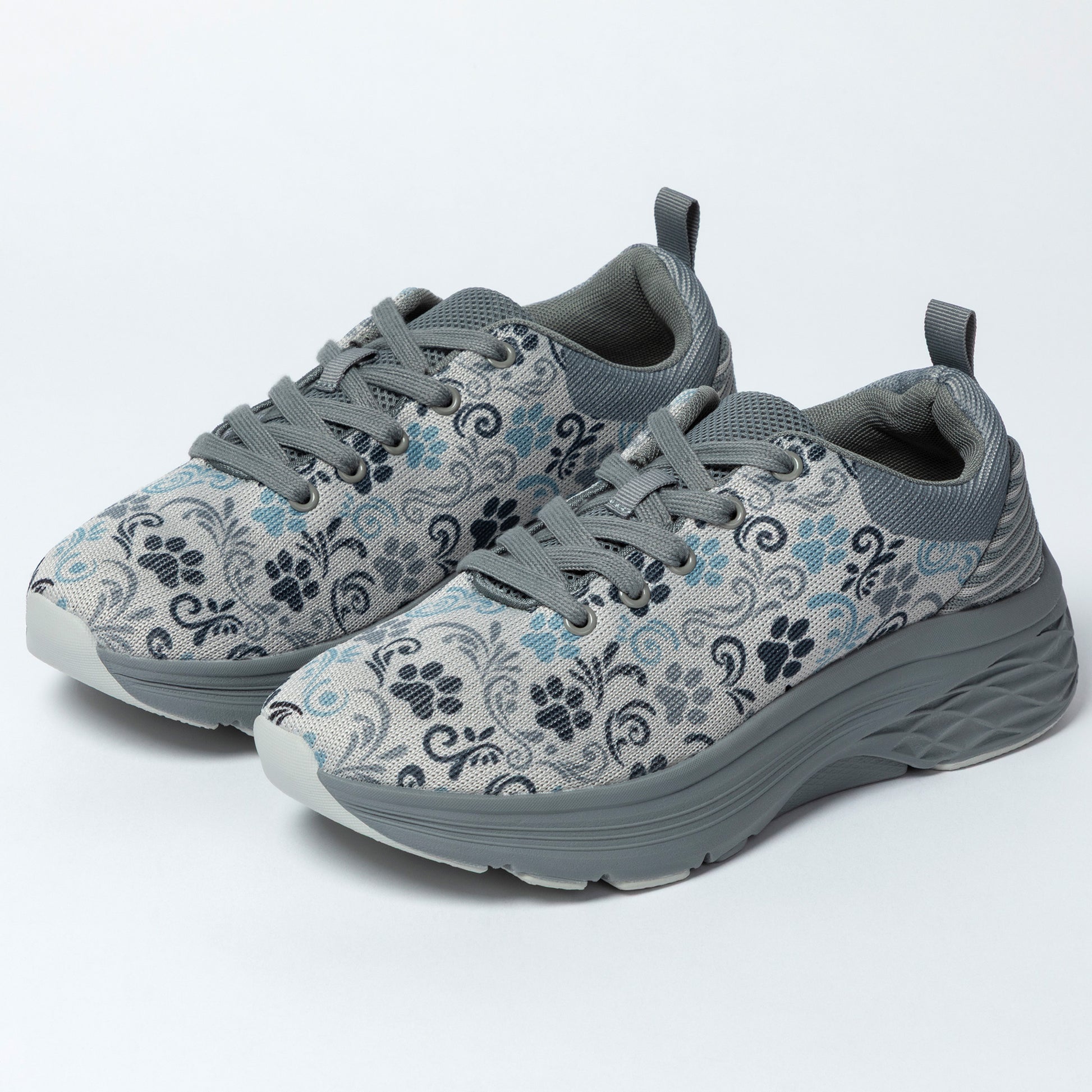 Gray sneakers with floral and paw print pattern on a white background.