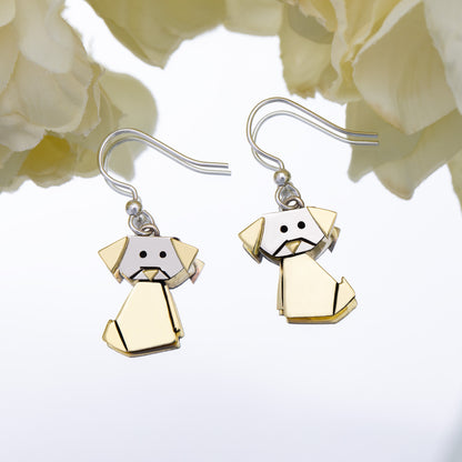 Dog-shaped origami style earrings on a white background with flowers