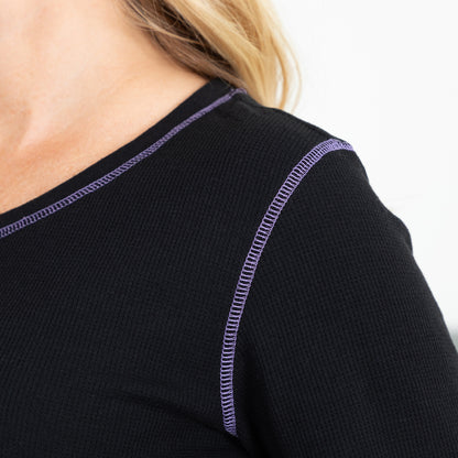 Close up of purple contrast stitching on a black thermal long sleeve tee.